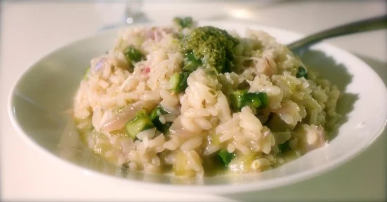 Asparagus and pesto risotto served in a shallow bowl.