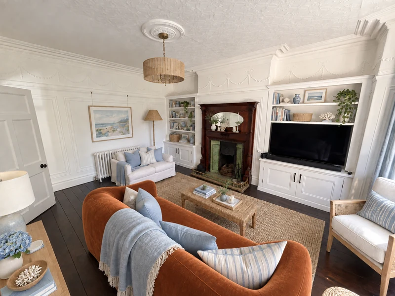 AI-generated coastal room with a sculptural burnt-orange velvet sofa in the foreground