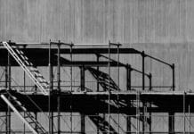 Scaffolding against a grey concrete background in an urban environment.