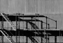 Scaffolding against a grey concrete background in an urban environment.